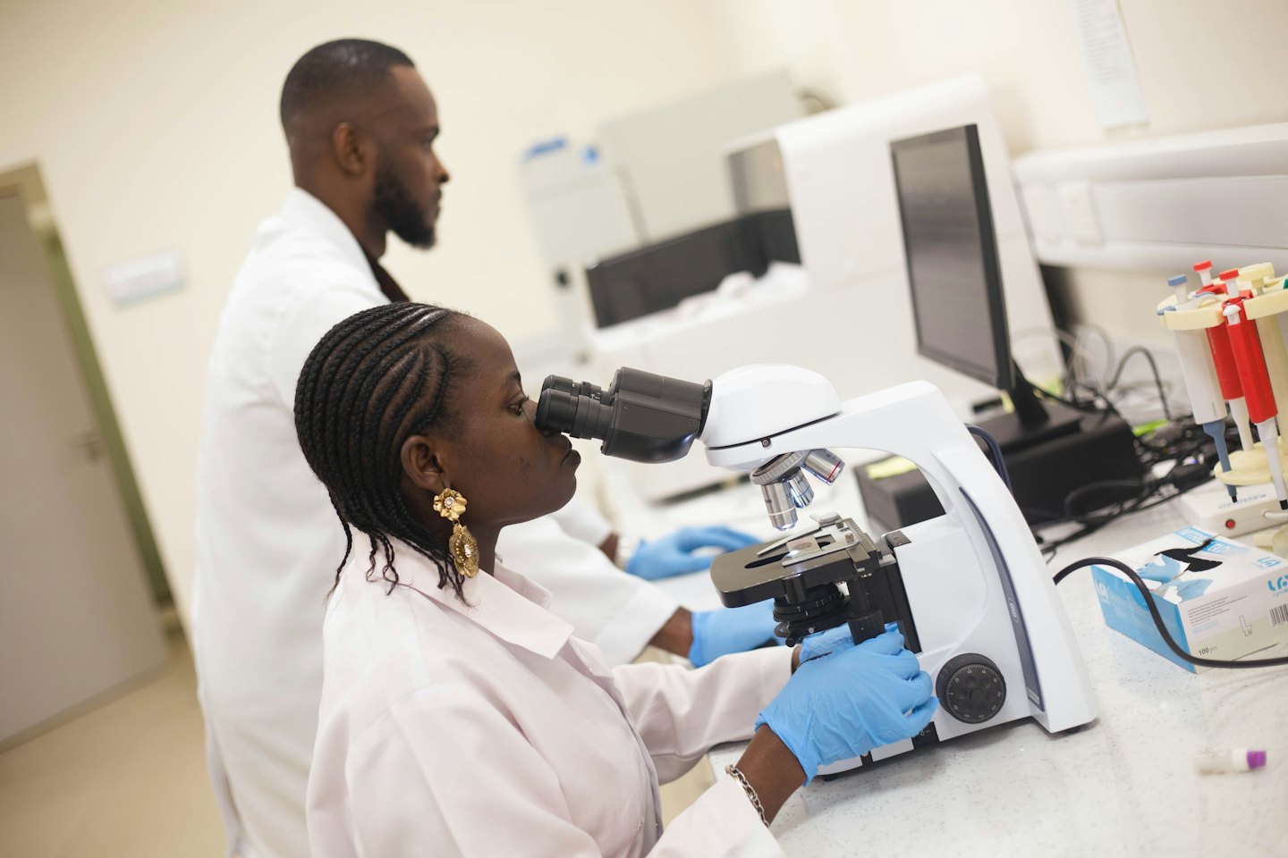 Two scientists conducting research with equipment in a laboratory.